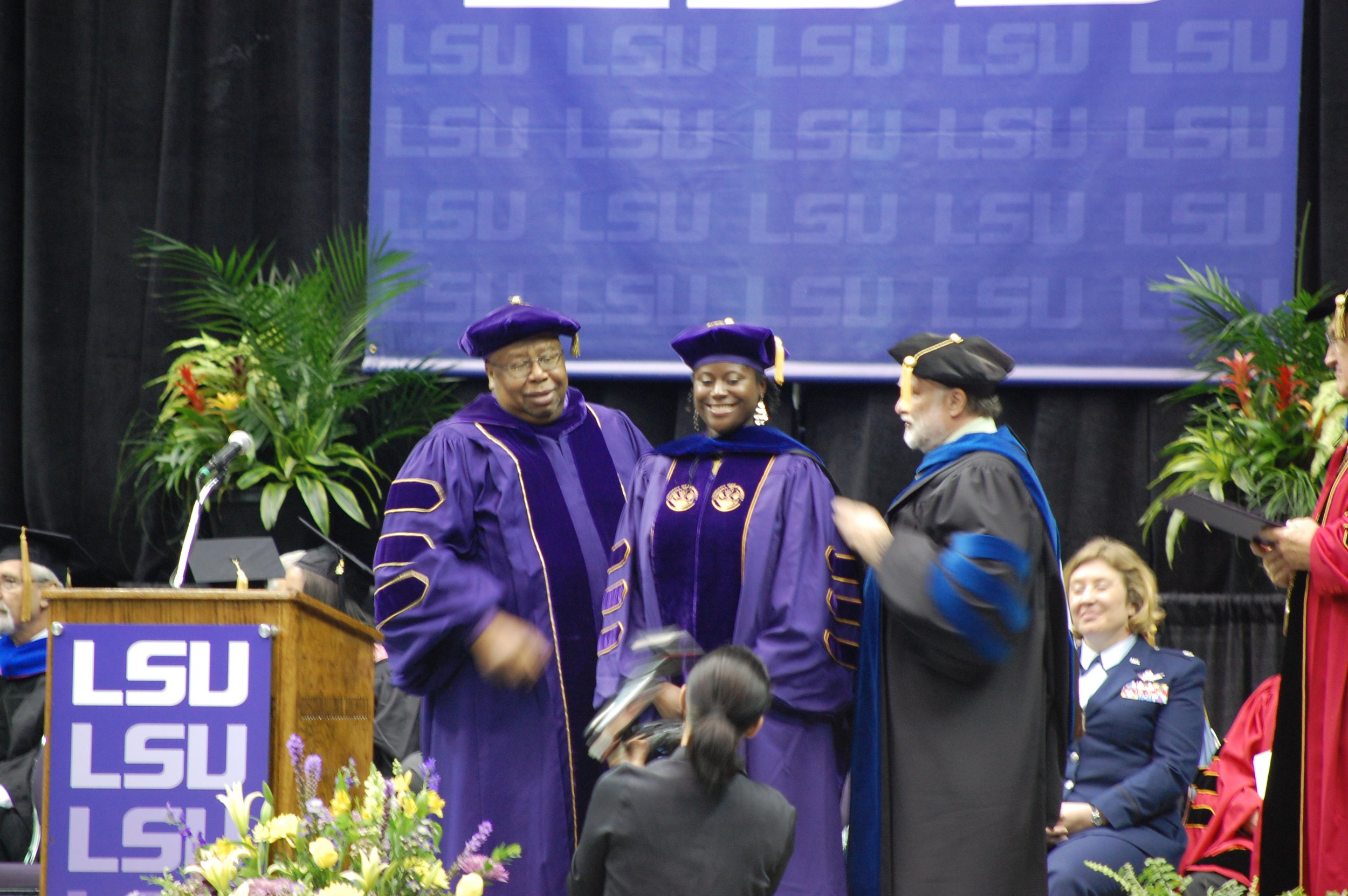 Dr. Warner hooding Ph.D. candidate, Dr. Ashleigh Wright. 