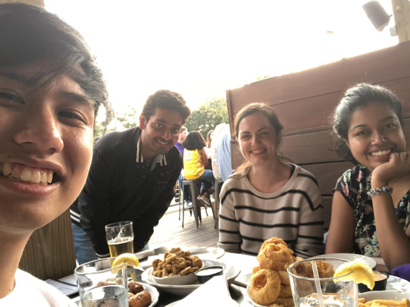 Lab members at restaurant table together smiling