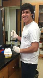 Photo of Jimmy Mickler in the lab holding a pippette