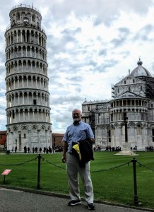 Dr. Moroney smiling standing in front of the Leaning Tower of Pisa