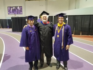 Peyton, Jimmy, and Dr. Moroney at graduation, standing side-by-side smiling in graduation regalia