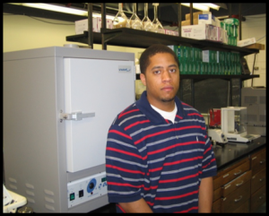 Bryan B. standing in front of oven in lab