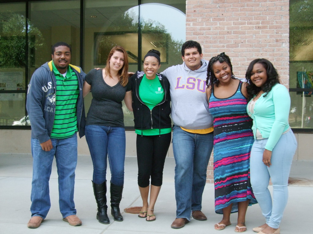 Group of undergraduate students posing in front of doors