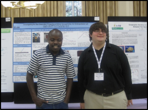 Wilson S. and Joey T. standing in front of poster