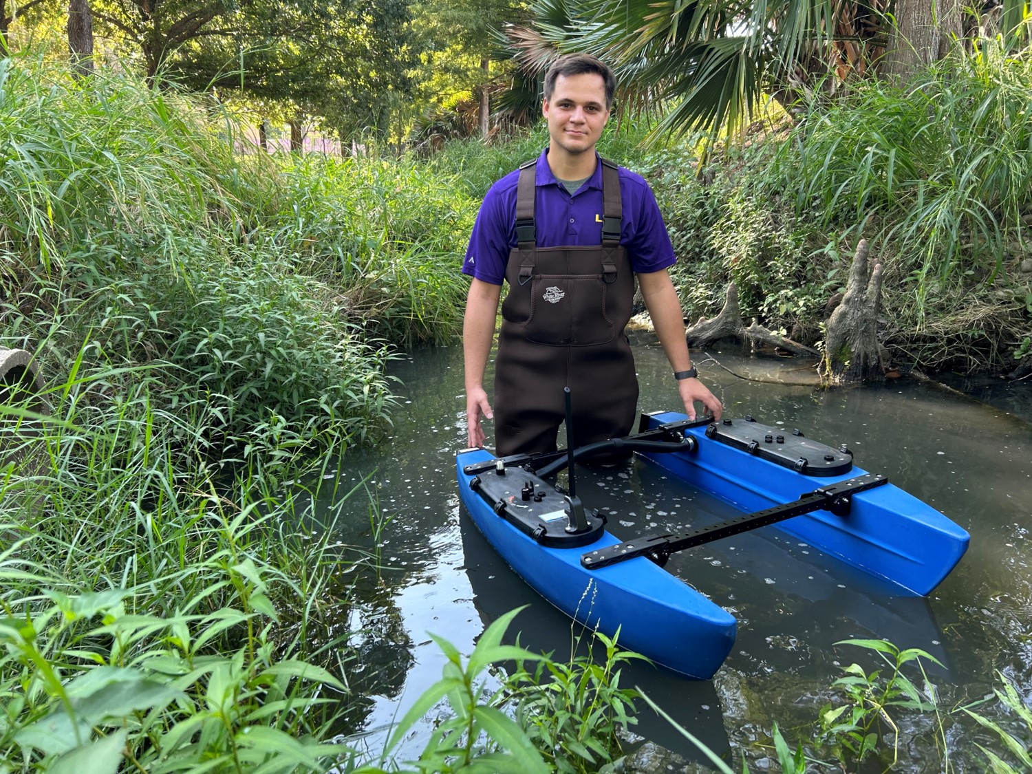 nick wading in water with blueboat