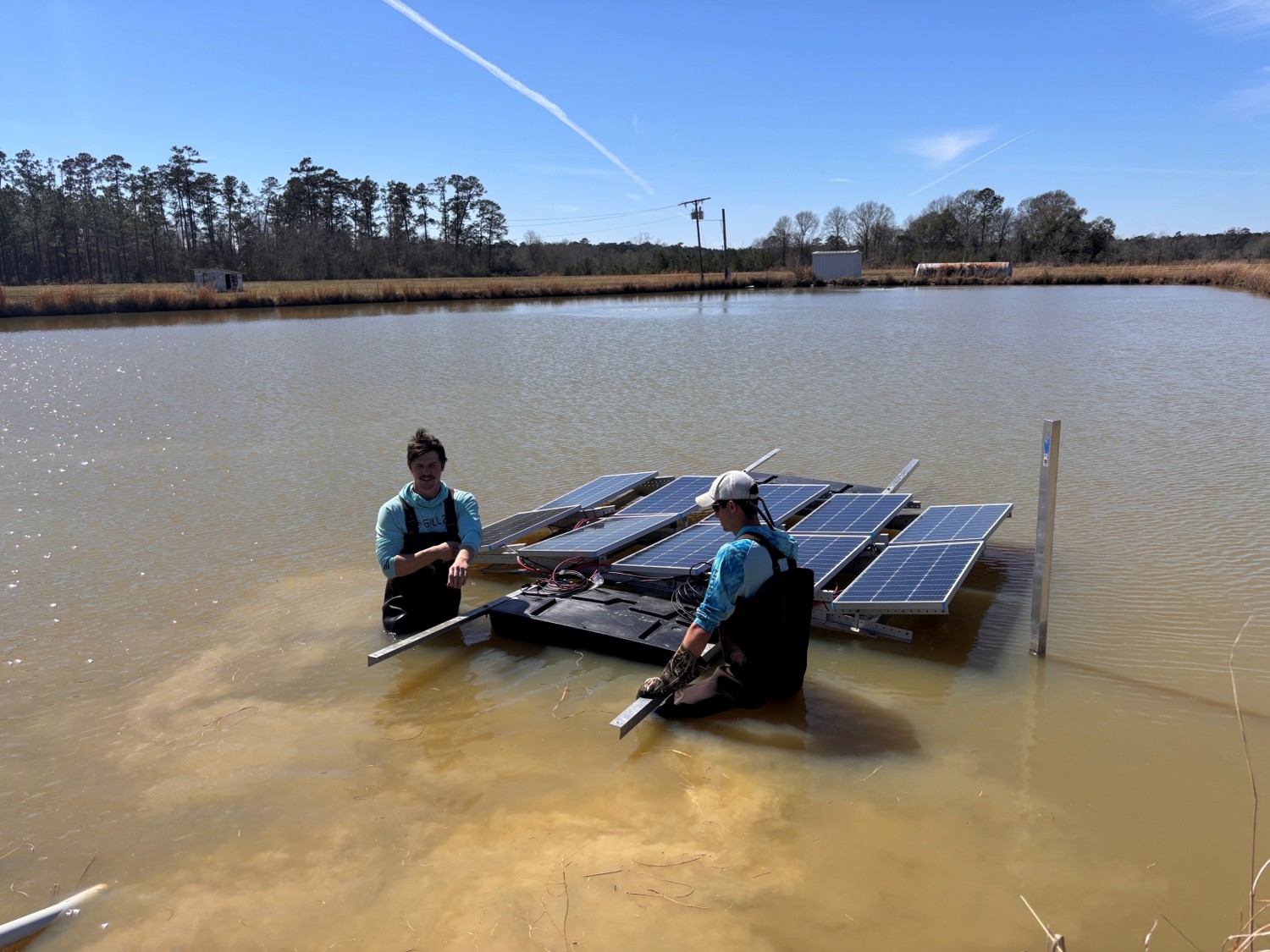 Mason and Hayes in water with solar panels