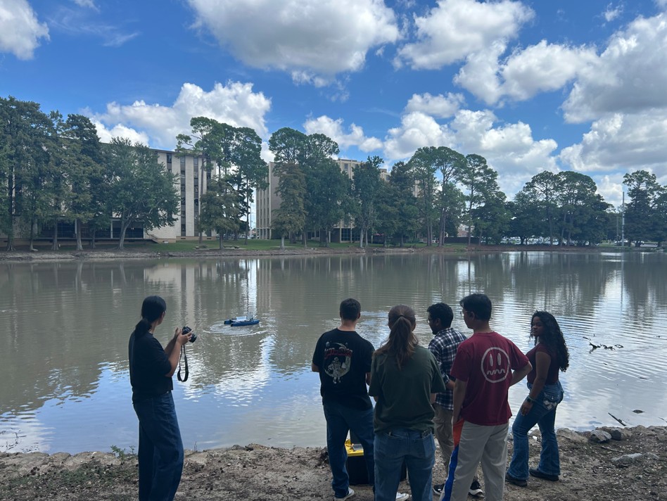 Team at the lake with the blueboat