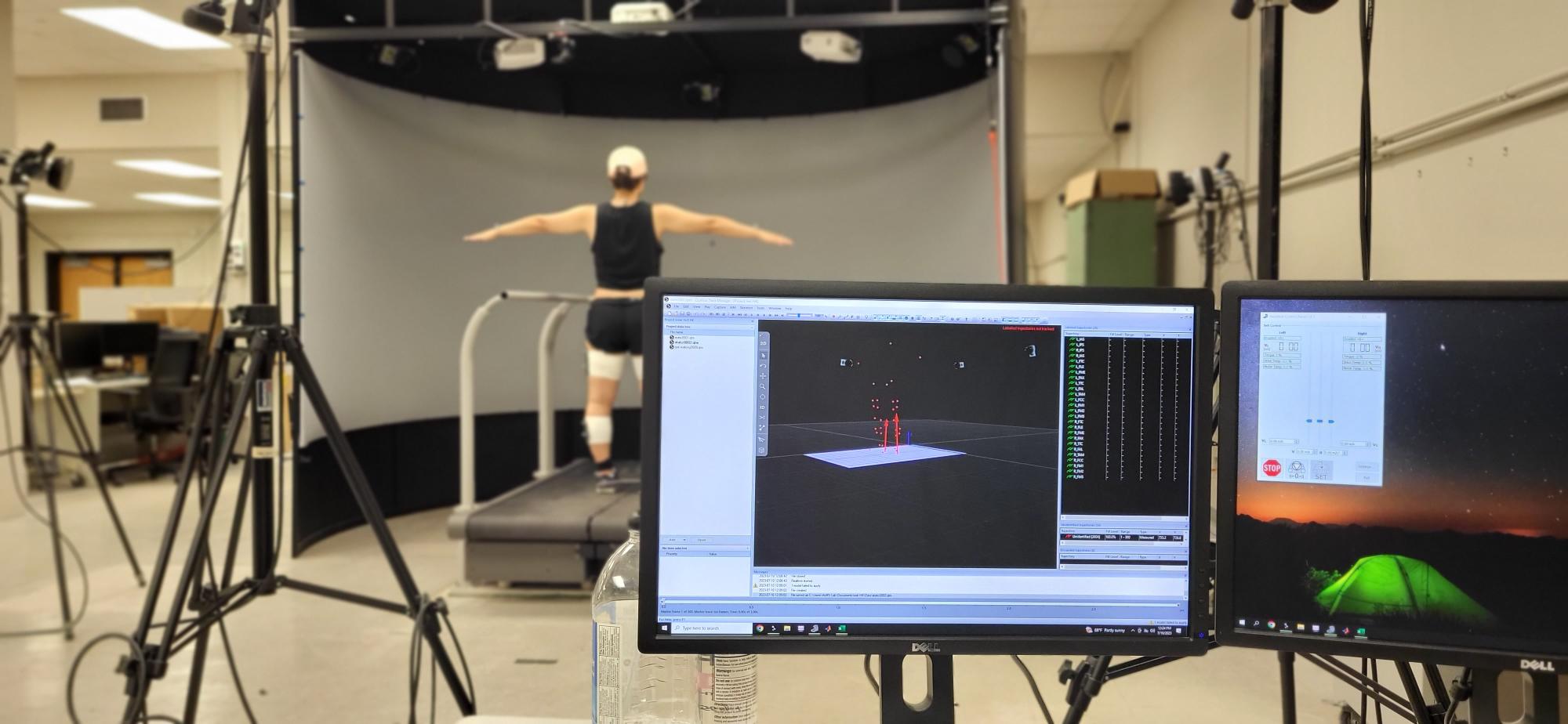 Participant standing on an instrumented treadmill while motion capture data are collected in the Musculoskeletal & Human Motion Lab.