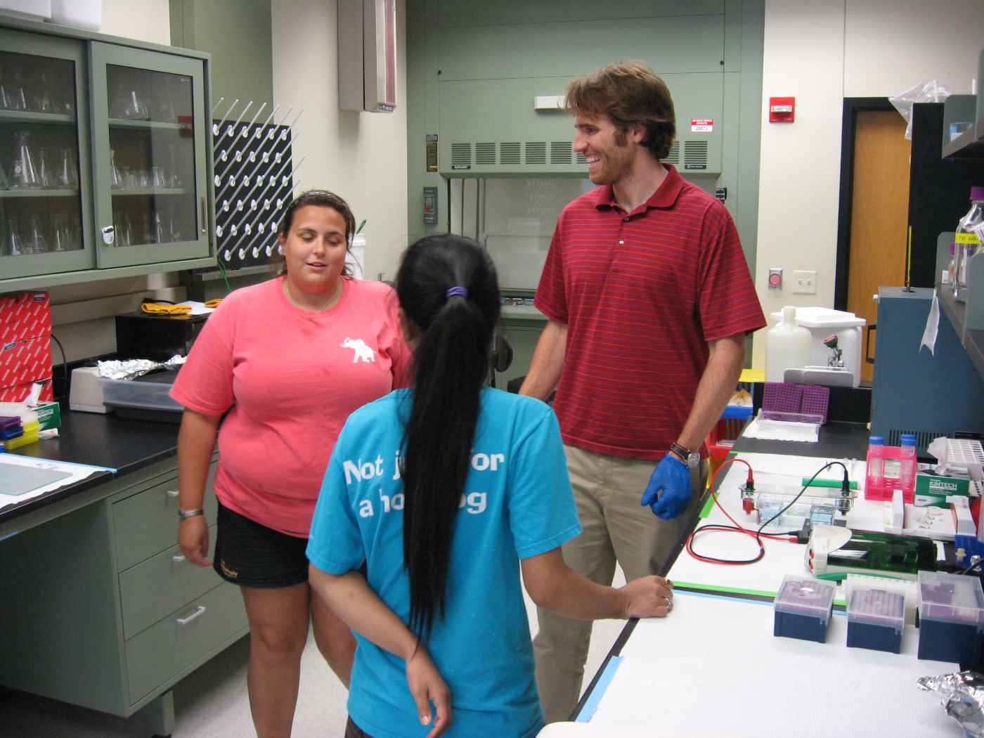 Brian, Danille, and Anupa laughing in the lab
