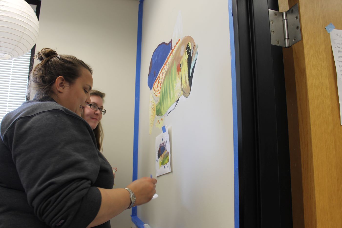 Julie and others help paint the Maruska lab logo