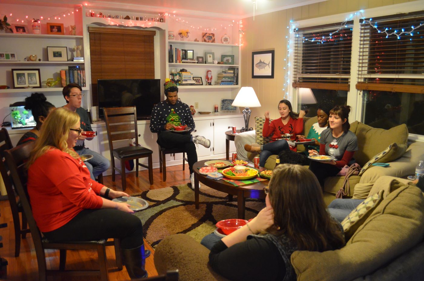 2016 Holiday Party lab members eating in the living room