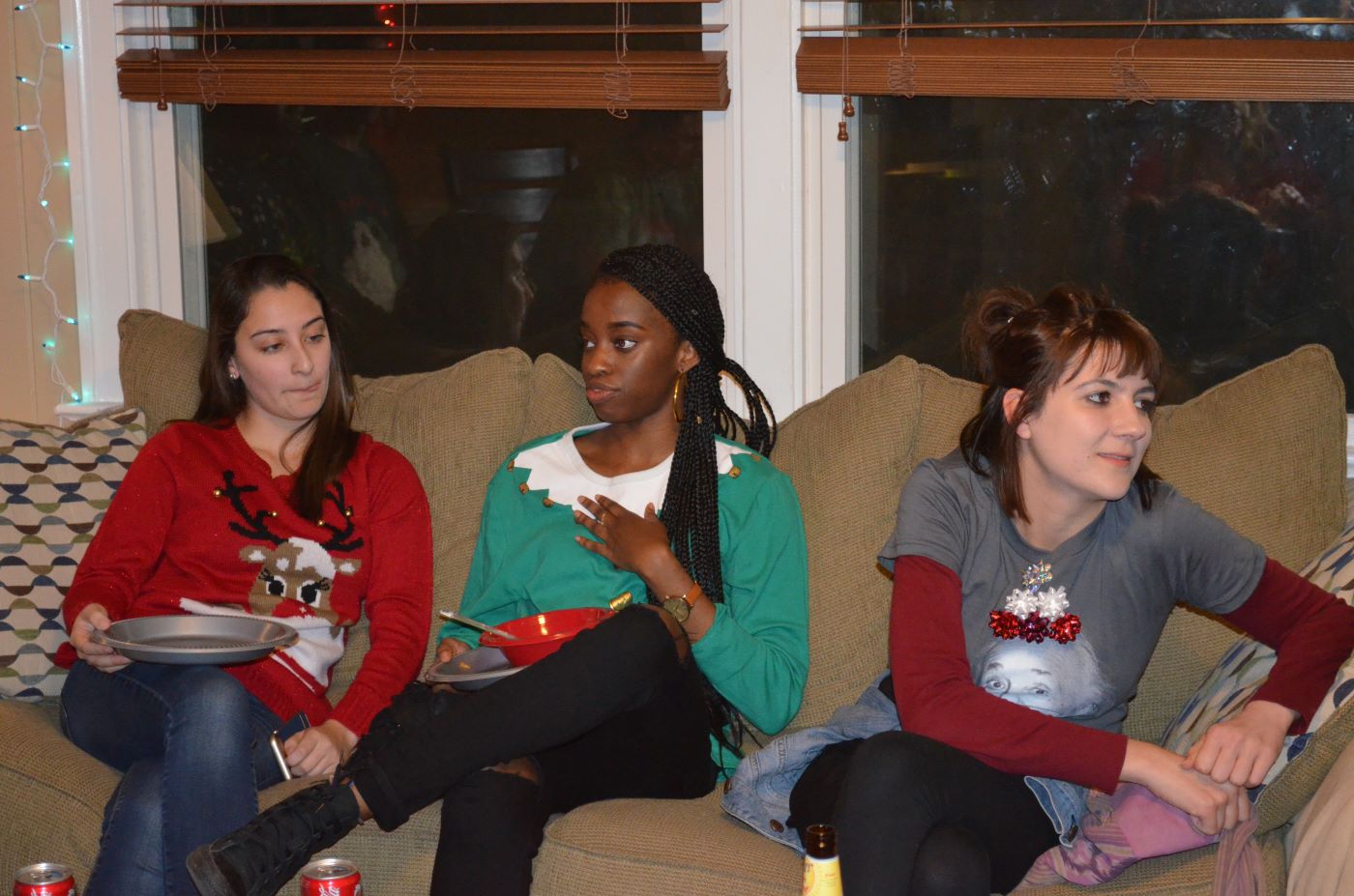 2016 Holiday Party lab undergrads talking on the couch