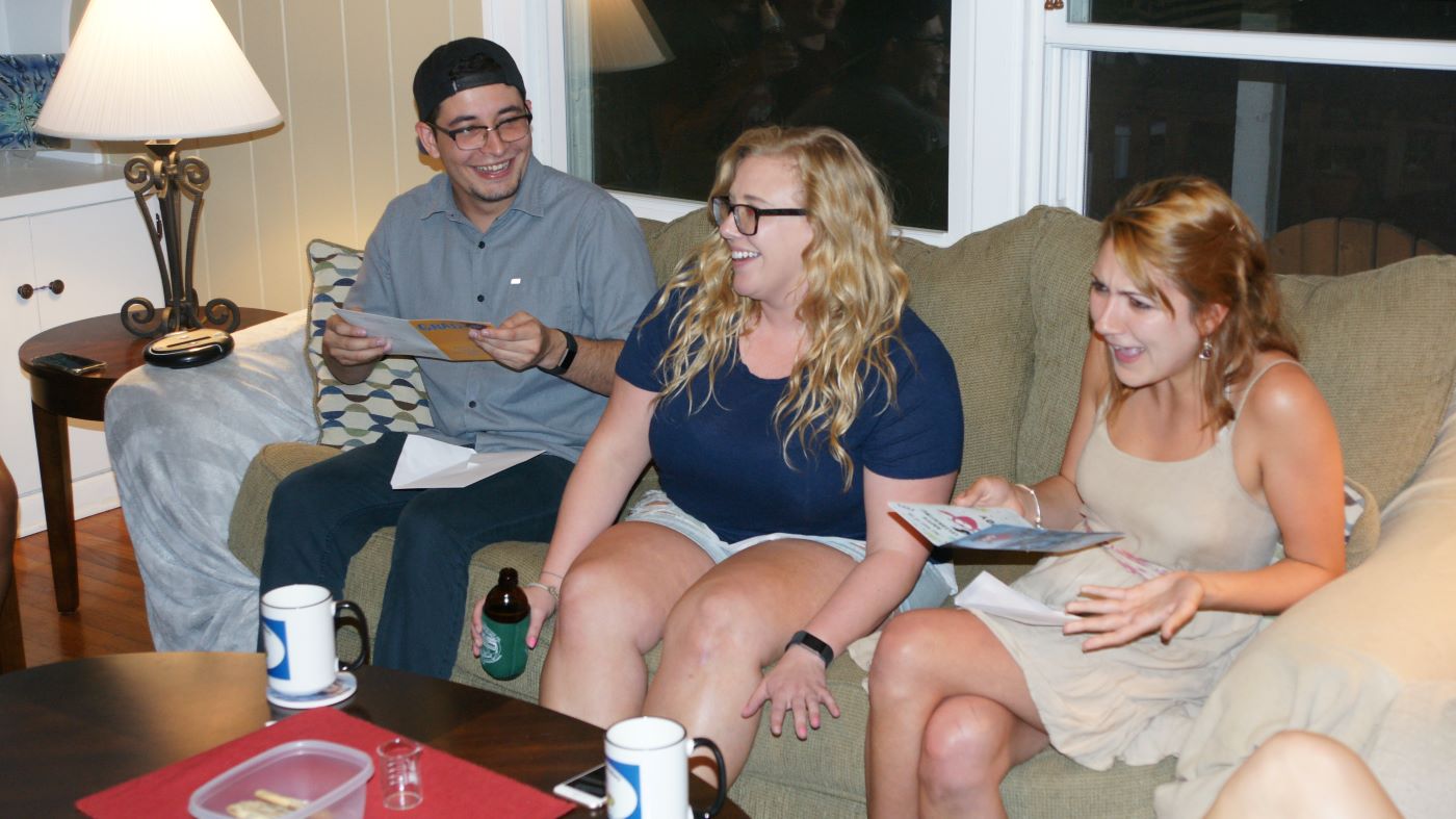 Daniel, Karen Jr., and Kara talking on a couch