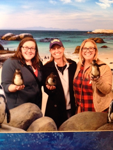 Karen, Karen Jr., and Julie holding penguins at the Audubon Aquarium of the Americas in New Orleans