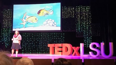 Julie tells an engaging story about Burt, Toni, and fish senses to a packed house at TEDx LSU