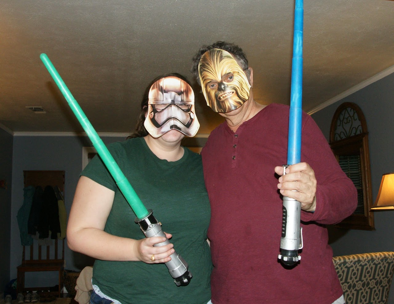 Karen Jr. and Alex with lightsabers and star wars masks