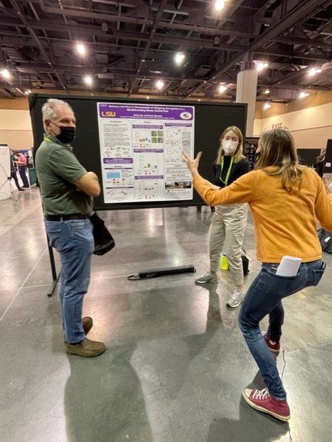 Emily presenting SICB poster to Suzy