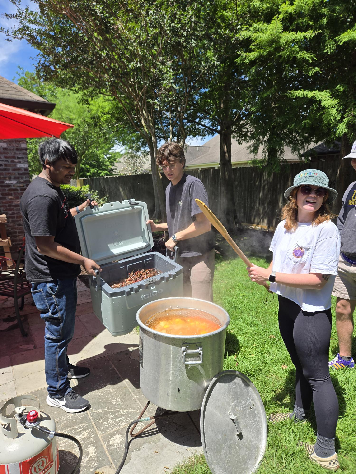 Photo from lab crawfish boil; holding crawfish bucket.