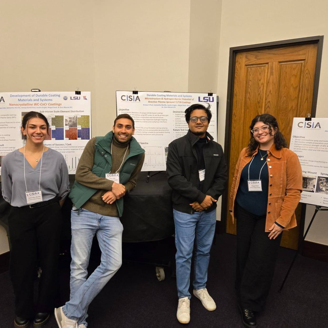 Students in front of posterboards.