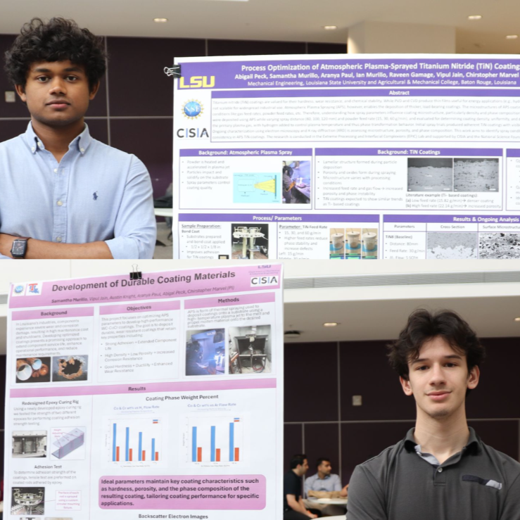 Ian and Raveen in front of their posters.