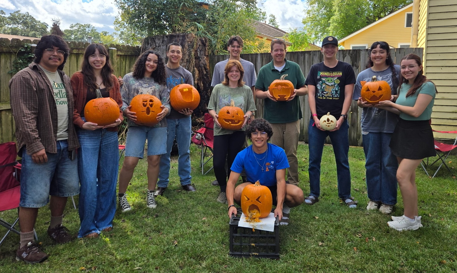 EPIC team at the annual pumpkin carving party (Fall 2025), all members holding their carved pumpkins.