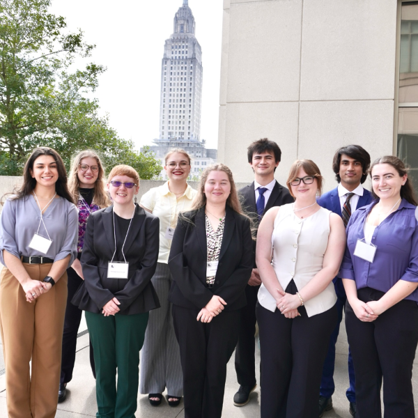 Sam with group of undergraduates in front of Baton Rouge capitol building.