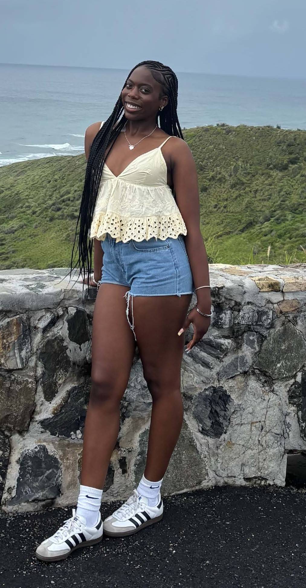 lc girl standing next to wall