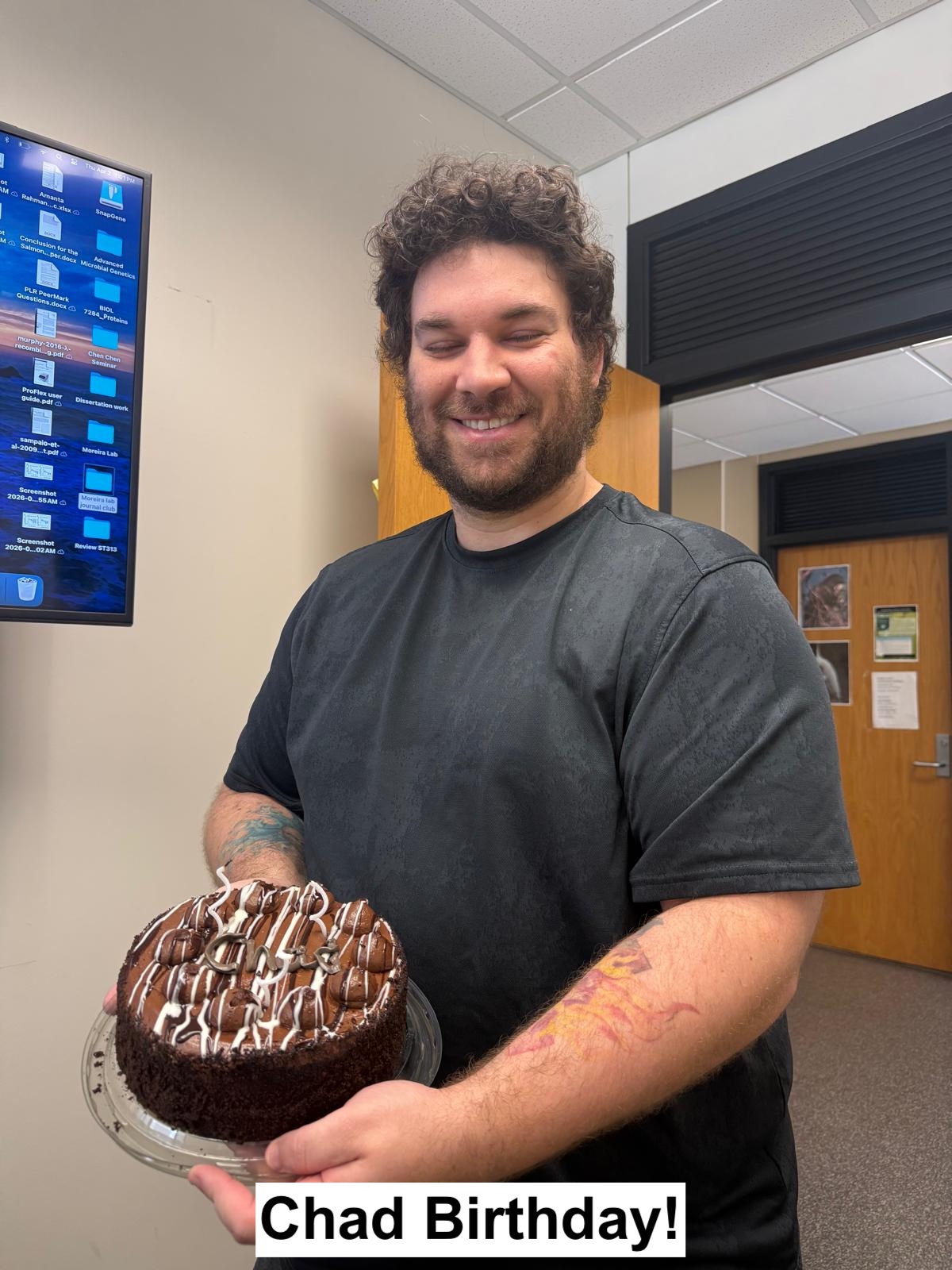 Chad Birthday: Chad is holding his cake with a smiley face