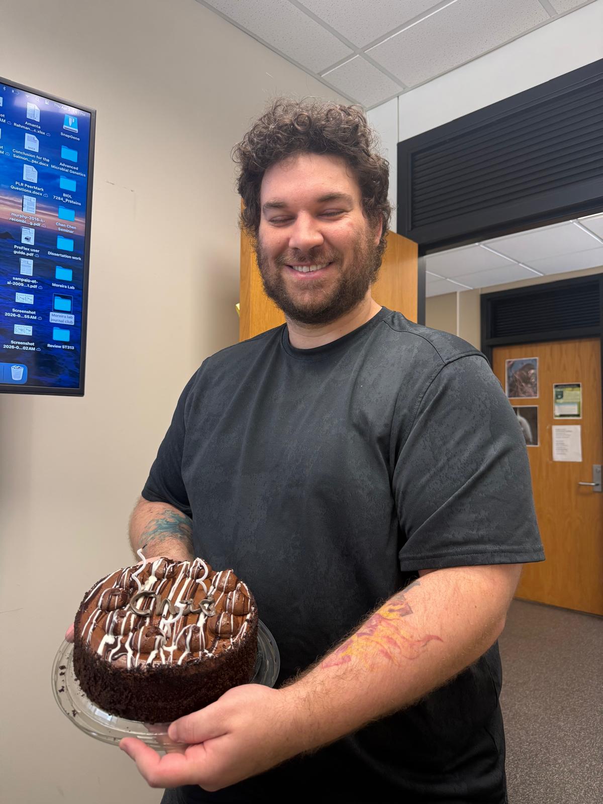 Chad is holding his Birthday cake.