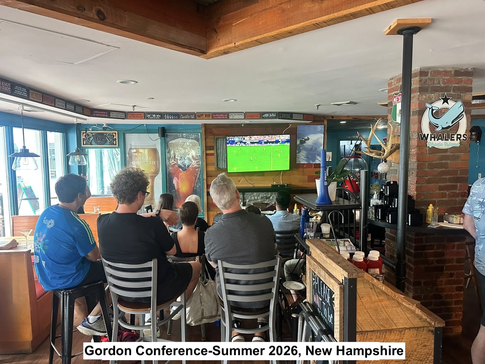 member of the conference are watching a soccer game