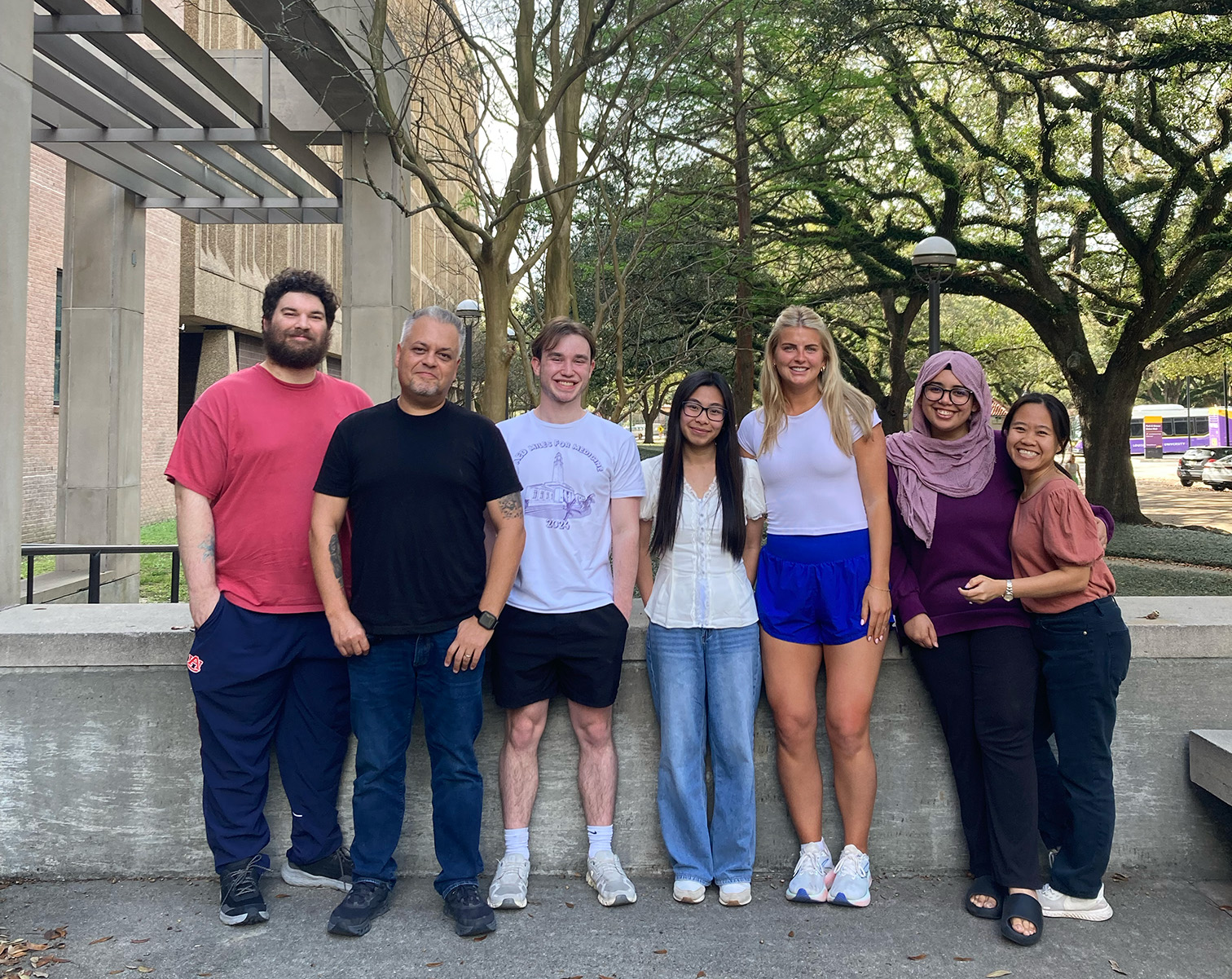 Seven people in Dr. Moreira lab member are standing and posting for the image.