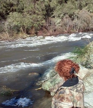 Erika standing next to a river