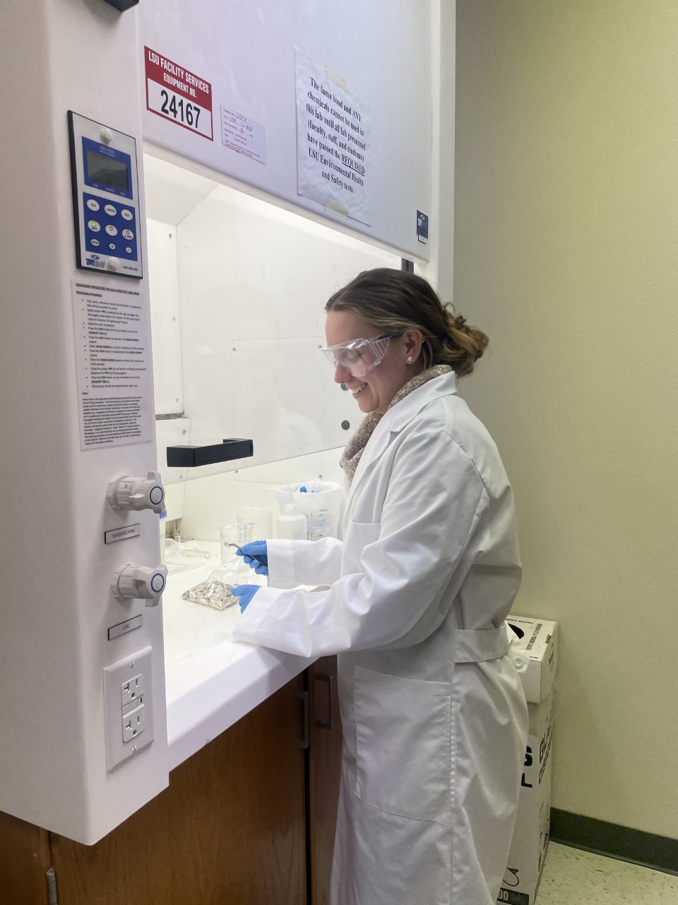 Sarah working with shells in a fume hood