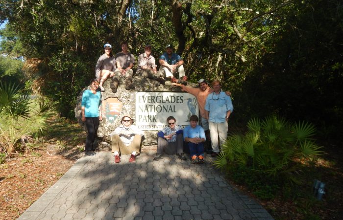 Students pose around Everglades National Park sign.