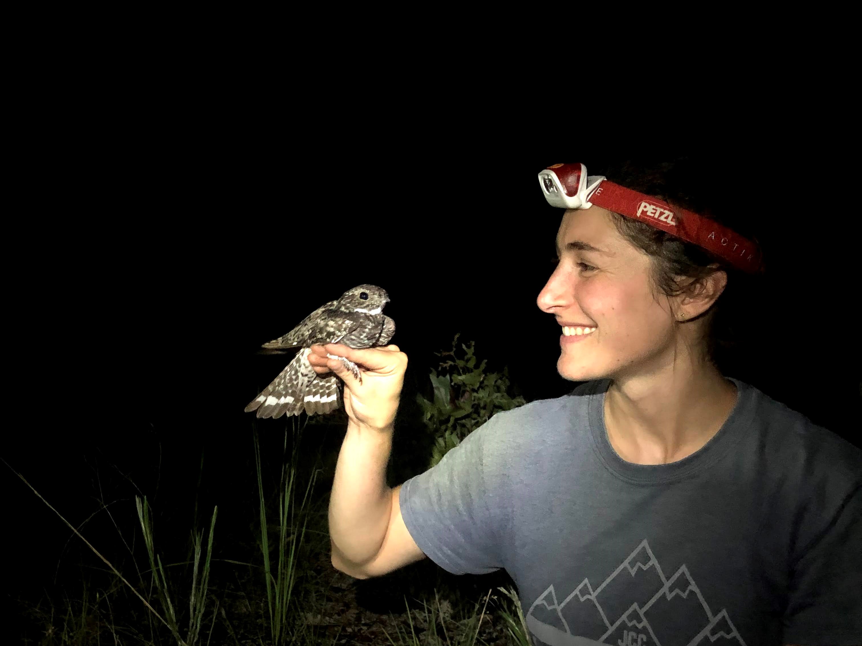 Image of Eliza Stein holding a Common Nighthawk