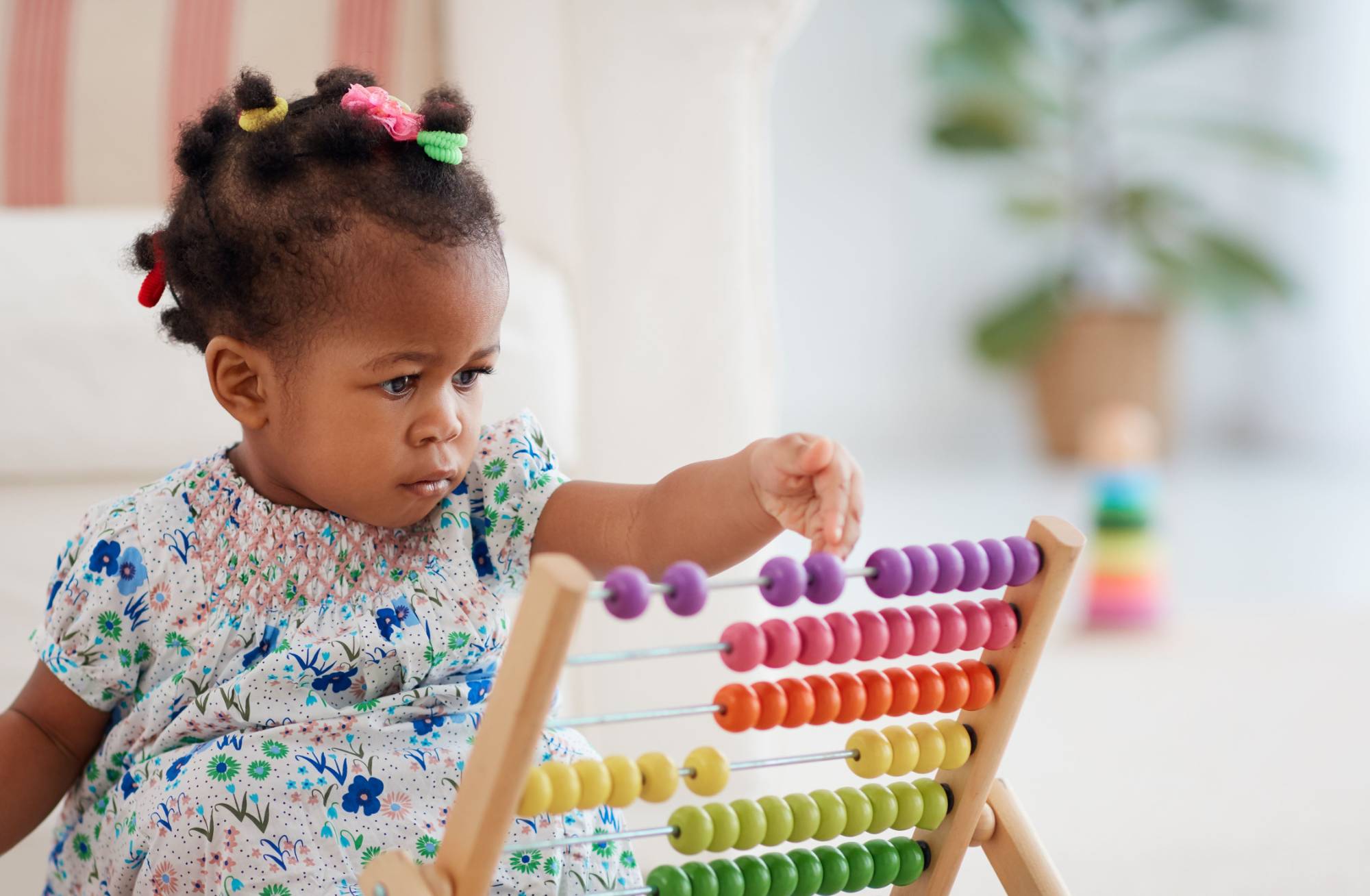 toddler playing with sliding beads