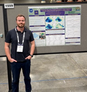 lee standing by poster