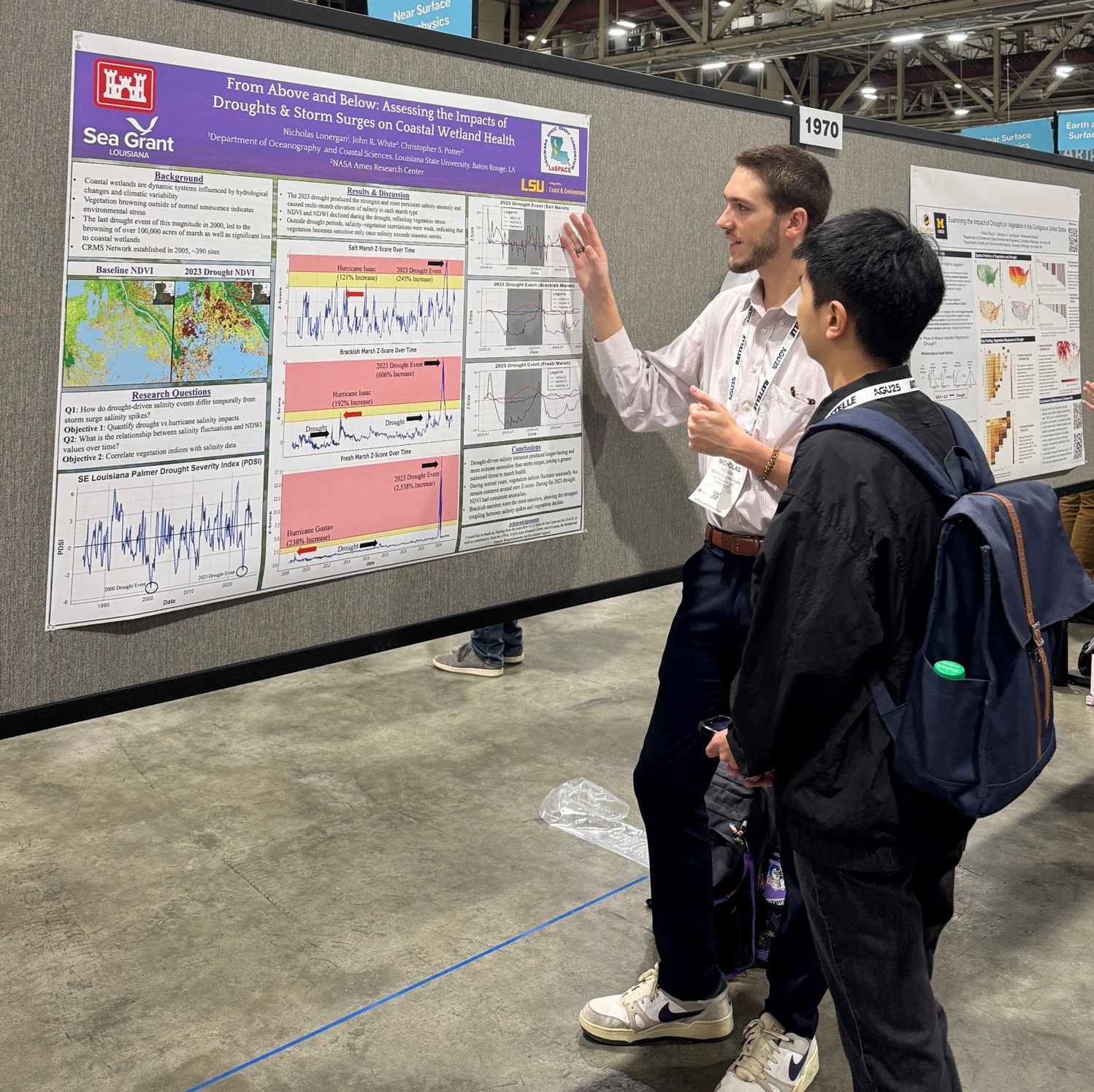 Nico standing next to poster