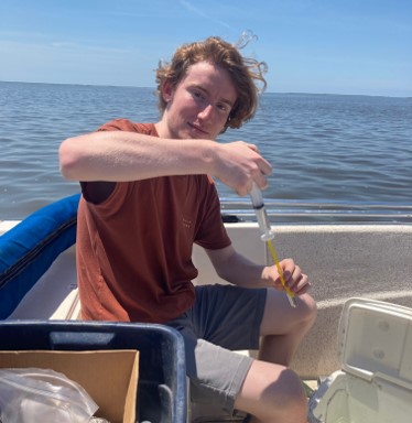 james filtering a water sample on the boat