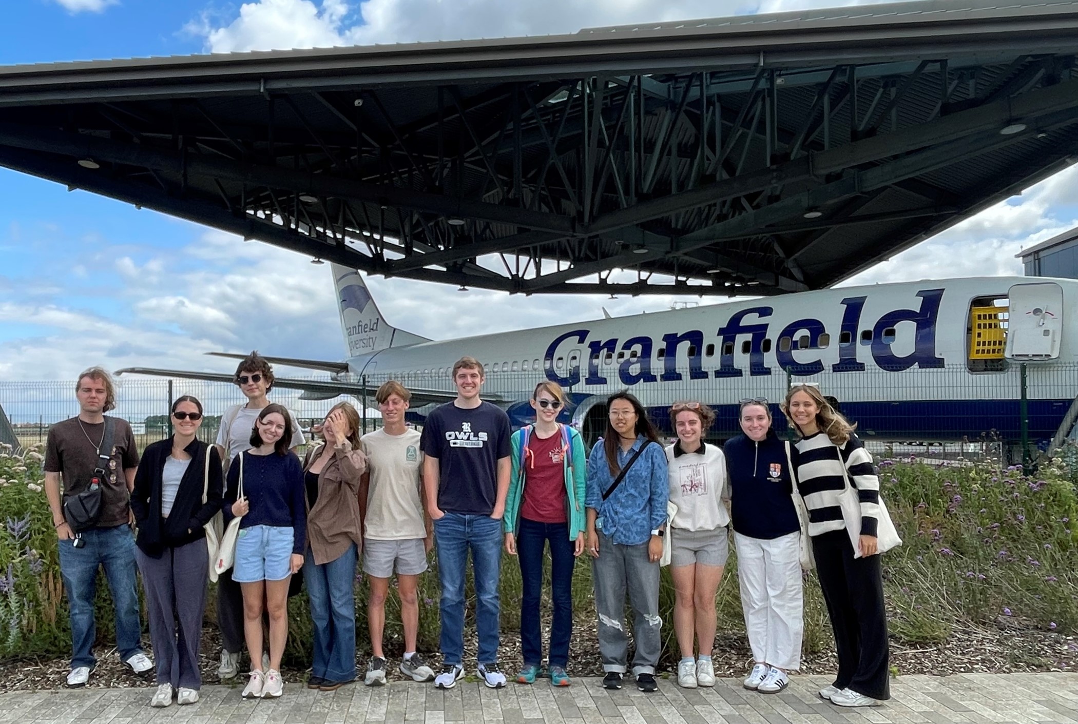 students in front of plane