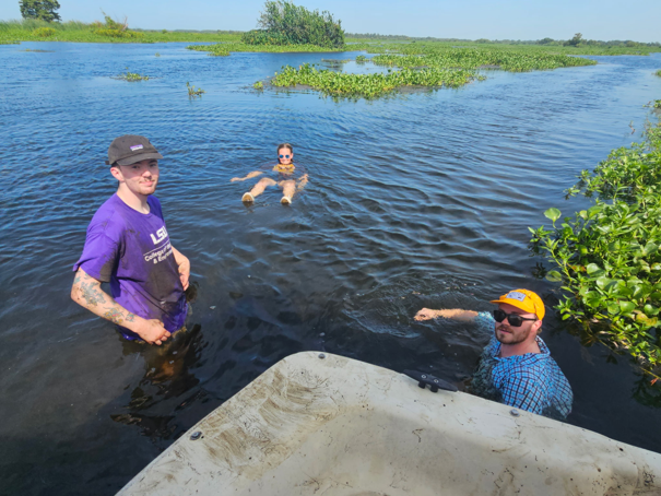 three people swimming in the water