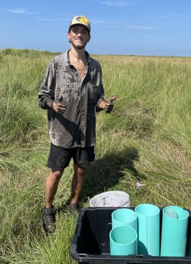 nico covered in mud in the marsh