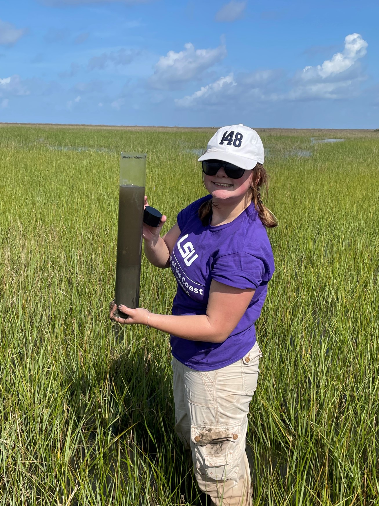 Katy holding a core in a wetland