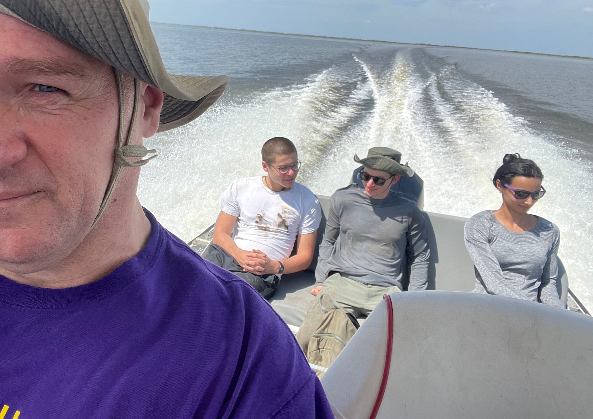 three people sitting on boat